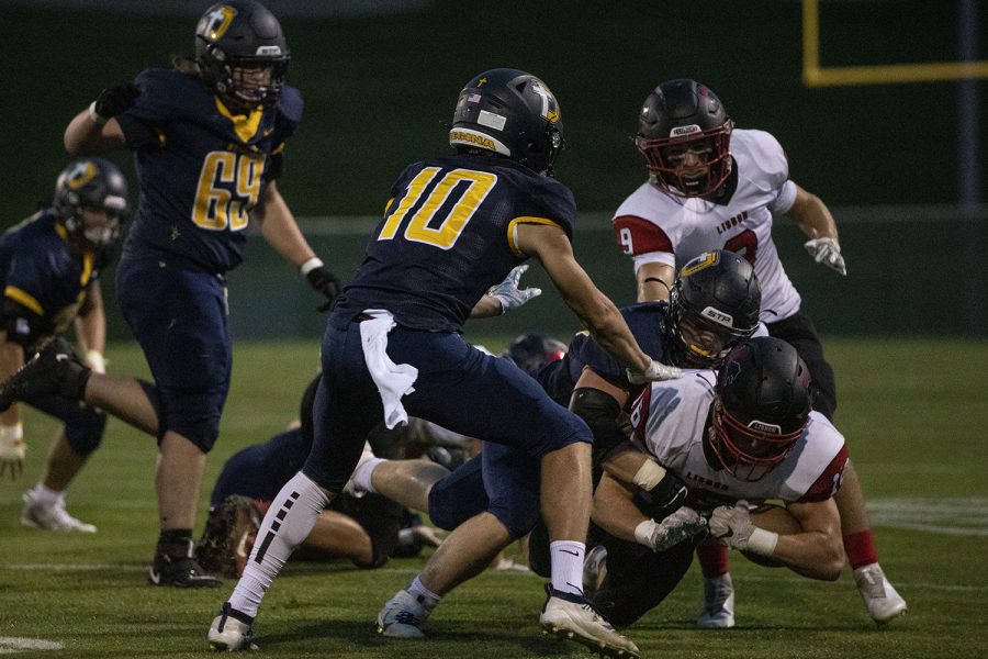 Lisbon Running Back Jamie Moore is tackled during Regina Catholic Education vs. Lisbon High School at Regina on Friday, Sept. 25, 2020. The Regals defeated the Lions 56-26. 