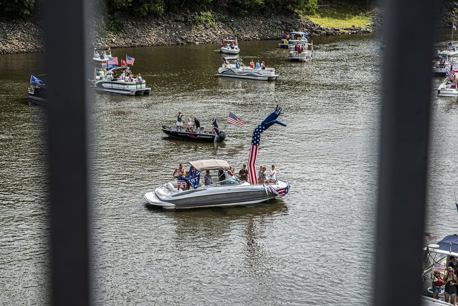 A group of boats decorated in Donald Trump paraphernalia pass under a bridge on Monday, Sept. 7, 2020. For Labor day, a group of local Trump supporters decided to drive their boats around Coralville Lake to celebrate and to show support for President Trump.