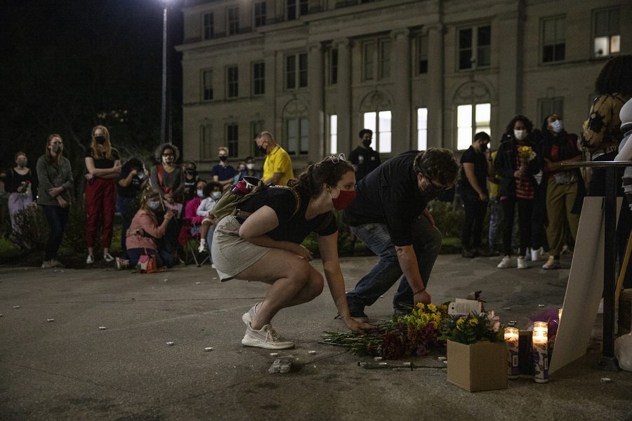 Participants lay flowers at the memorial of Makeda Scott during a service held for Scott on the University of Iowa Pentacrest on Friday, September 25, 2020. According to the Johnson County Sherriff, Scott had drowned at Lake MacBride on June 7th of this year. Scott was 21 at the time, having recently graduated from Iowa with a degree in gender, women's, and sexuality studies. (Ryan Adams/The Daily Iowan)