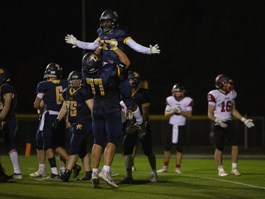 Regina Running Back Theo Kolie celebrates with Offensive Tackle Josh Gaffey after a touchdown during Regina Catholic Education vs. Lisbon High School at Regina on Friday, Sept. 25, 2020. The Royals defeated the Lions 56-26. (Katie Goodale/The Daily Iowan)