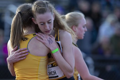Iowa runner Mary Arch hugs her teammate after the 3000m run at the Musco Twilight Invitational at the Cretzmeyer Track on Saturday, April 13, 2019. Arch finished fourth with a time of 10:23:58. The Hawkeyes won 10 events during the meet. The Iowa women ranked first with 183 points, and the men ranked fifth 76 points.
