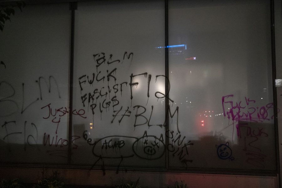 Graffiti is seen on the outside of the MidwestOne Bank during a Black Lives Matter protest organized by the Iowa Freedom Riders on Sunday, Aug. 30, 2020. This was the third protest of a four day protest streak in which protesters took to the street to put pressure on the City Council. These protests lead up to a Tuesday meeting during which three of their demands will be discussed. 