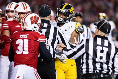 Officials seperate Iowas Ihmir Smith-Marsette and Wisconsins Madison Cone during a football game between Iowa and Wisconsin at Camp Randall Stadium in Madison on Saturday, November 9, 2019. The Badgers defeated the Hawkeyes, 24-22. 