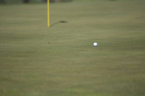 A ball lands close to the flag during a golf invitational at Finkbine Golf Course on Saturday, April 20, 2019. Iowa came in first with a score of 593 against 12 other teams.