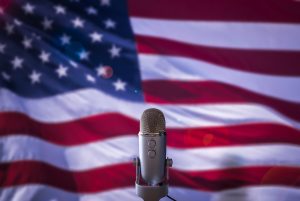 A Microphone In Front Of A USA Flag Ready For A Public Address From The President Or Other Government Figure.