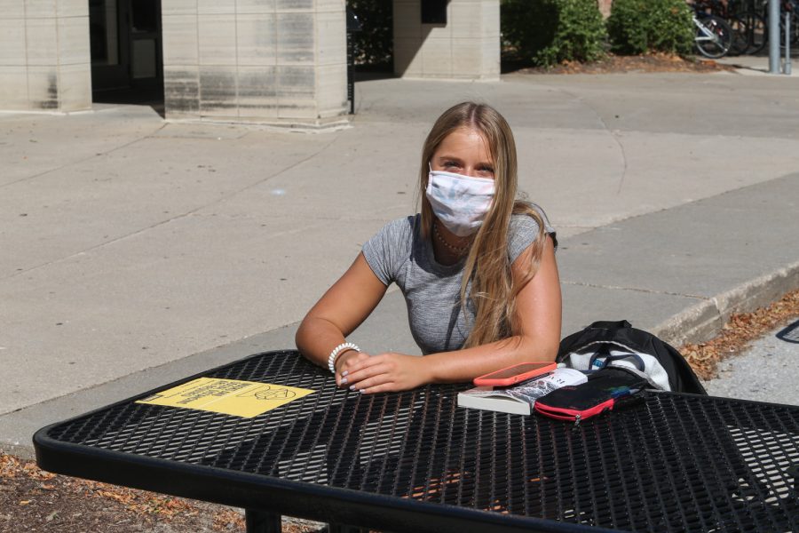 Taylor Ford poses for a portrait on Thursday, Sept. 3 in front of Burge Residence Hall in Iowa City. Ford was released from a quarantine floor in Burge that morning and was taking advantage of her release by reading outside in the afternoon.