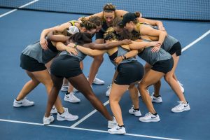 Iowa players huddle before doubles play during a womens tennis match between Iowa and Maryland at the HTRC on Sunday, April 7, 2019. The Hawkeyes defeated the Terrapins, 6-1. 
