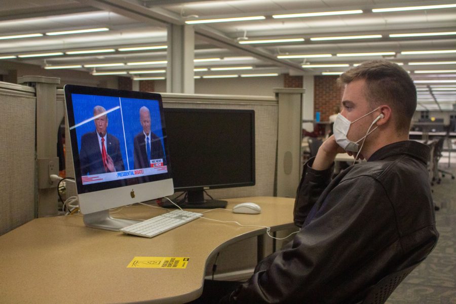 President Donald Trump and former Vice President Joe Biden face off in the final Presidential Debate of 2020 as University of Iowa senior, Trevor Johnson, watches in the Main Library on Thursday, Oct. 22, 2020. Johnson said, “I want to see what is going to happen in this debate and if it is going to be a circus…so far it hasn’t been too bad.” He went on to say, “They haven’t he’d the need to really mute their mics, but we’ll see what happens the rest of the debate. The most important thing is that they remain civil and presidential.”