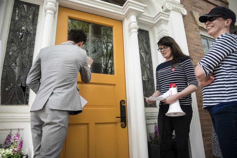 Matt McBride knocks on the door of Bruce Harrelds residence on May 4, 2018. UIs non-tenured faculty—grown to 52% since 2011—advocated for greater job security, fair pay, and benefits.