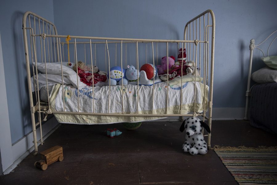 A crib full of toys is seen in the children’s upstairs bedroom inside of the Villisca Ax Murder House in Villisca, Iowa on Sept. 30, 2020. Villisca is the site of one of the oldest cold cases in Iowa in which eight people were murdered in their beds. The killer was never found, sparking many theories and interest in the case. On the night of the killings, this room was occupied by all of the Moore children. The crib now sits filled with toys. 