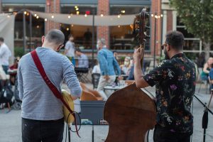 Blake Shaw and Dan Padley perform outside Goosetown Cafe on Tuesday Oct. 7, 2020. Guests watched from their tables outside as others gathered within the street to listen. 