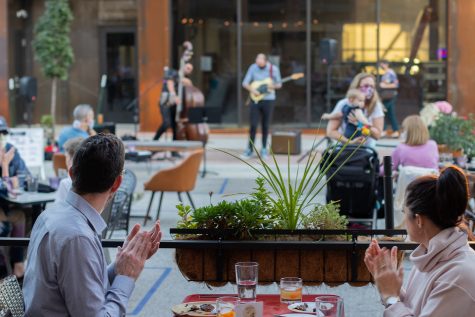 Audience members applaud Blake Shaw and Dan Padley as they perform outside Goosetown Cafe on Tuesday Oct. 7, 2020. Guests watched from their tables outside as others gathered within the street to listen. 