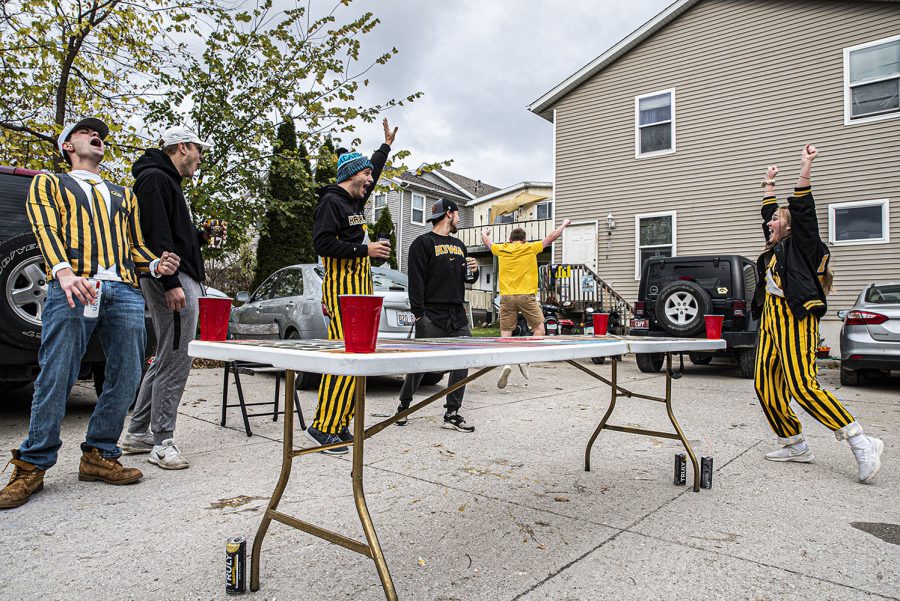 A group of University of Iowa seniors play a game of dye outside while tailgating on Saturday, October 24th, 2020. Despite it being an away game, a handful of Iowa City residents still decided to celebrate with their own, small scale tailgates. “Yeah there’s a lot going on right now, but we all live together anyway so this is safe and for a lot of us, this is our last first tailgate of the season so we figured we had to do something. 