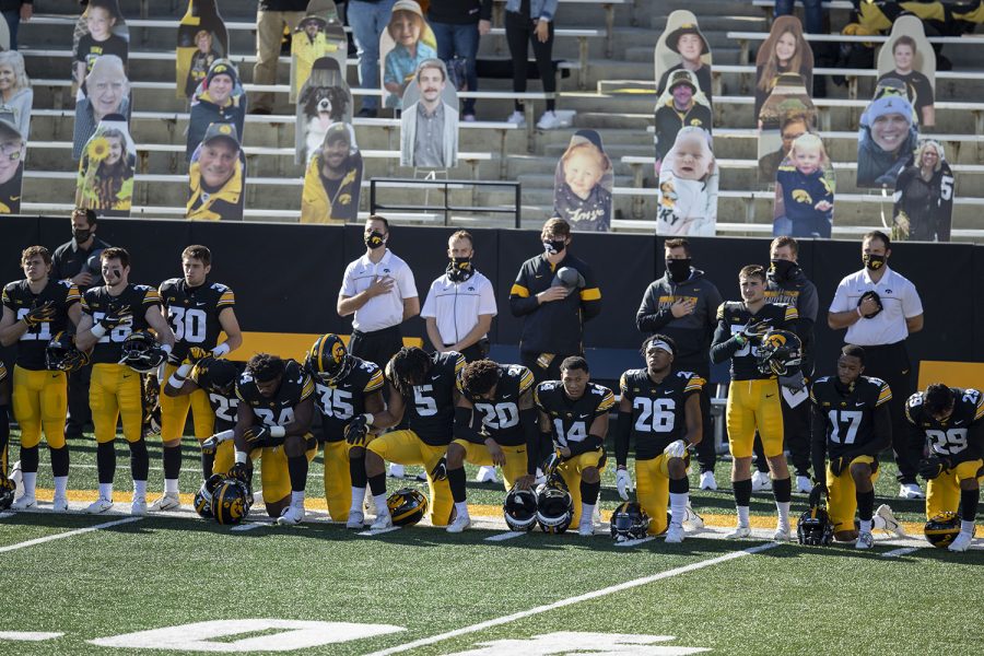 Players kneel and stand for the national anthem before the Iowa v Northwestern football game at Kinnick Stadium on Saturday, Oct. 31, 2020. Head Coach Kirk Ferentz did not kneel for the anthem.The Wildcats defeated the Hawkeyes 21-20. 