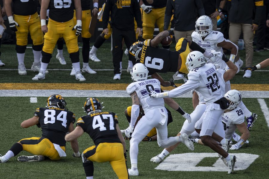 Iowa+Wide+Receiver+Ihmir+Smith-Marsette+dives+over+other+players+during+the+Iowa+v+Northwestern+football+game+at+Kinnick+Stadium+on+Saturday%2C+Oct.+31%2C+2020.++The+Wildcats+defeated+the+Hawkeyes+21-20.