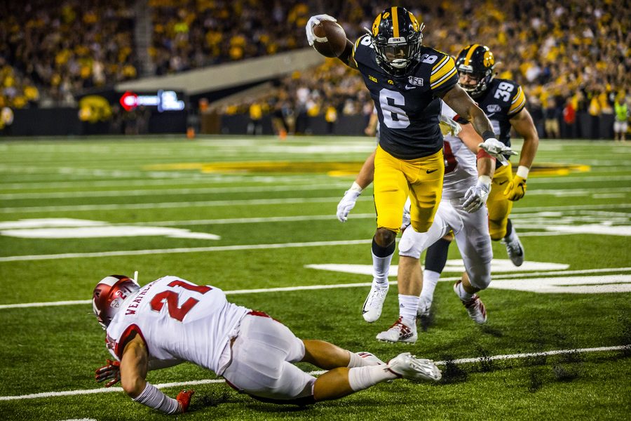 Iowa wide receiver Ihmir Smith-Marsette jumps over Miami (Ohio) defensive back Sterling Weatherford during the Iowa football game against Miami (Ohio) at Kinnick Stadium on Saturday, August 31, 2019. The Hawkeyes defeated the Redhawks 38-14.