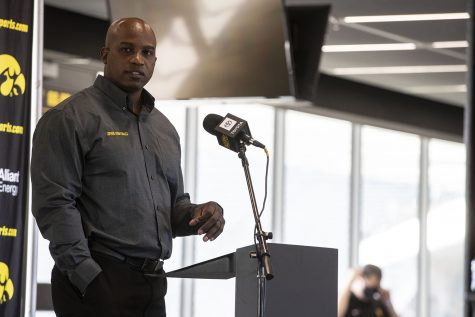 Wide Receivers coach Kelton Copeland walks up to the podium to address members of the press during football media day in Kinnick Stadium on Thursday, Oct. 8, 2020. Copeland and all Iowa coaches wore masks until they reached the podium six feet from the first row of chairs.