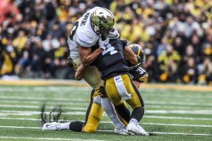 Iowa defensive back Dane Belton tackles Purdue tight end Brycen Hopkins during the Iowa football game against Purdue at Kinnick Stadium on Saturday, Oct. 19, 2019. The Hawkeyes defeated the Boilermakers 26-20.