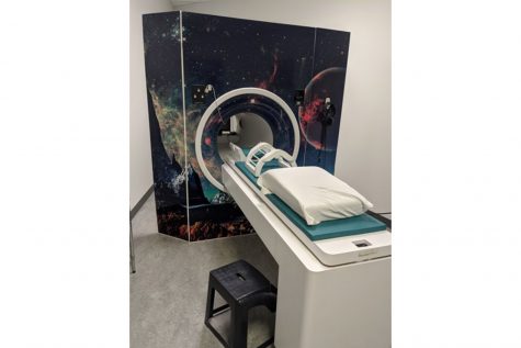 Photo of vinyl wrap with outer-space graphics  attached to the MRI scanners. Contributed.