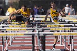 Iowas Aaron Mallett clears a hurdle alongside teammate Chris Douglas during the 18th annual Musco Twilight at Francis X. Cretzmeyer Track on Saturday, April 22, 2017. Iowas men and womens track and field finished first overall in the Musco Twilight with a 237.5 and 203 respectively. 