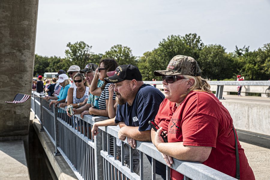A group of Donald Trump supporters stand over Coralville Lake watching as decorated pro-Trump boats pass underneath on Monday, September 7th, 2020. For Labor day, a group of local Trump supporters decided to drive their boats around Coralville Lake to celebrate and to show support for President Trump. 