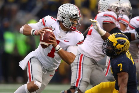 Justin Fields (1) of the Ohio State Buckeyes tries to get around the tackle of Khaleke Hudson (7) of the Michigan Wolverines during the second half at Michigan Stadium on November 30, 2019 in Ann Arbor, MI. Fields was one of the proponents of restarting the Big Ten conference amind COVID-19 pandemic. (Gregory Shamus/Getty Images/TNS)