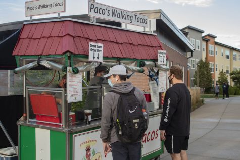 Workers for Paco’s Tacos, Ted and Butch, prepare street tacos and walking tacos for residents at Aspire at West Campus Apartment Complex on Oct. 1, 2020. Aspire at West Campus is partnering with local food vendors to supply dine-out options during COVID-19.