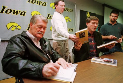 Former University of Iowa head football coach Hayden Fry signs copies of his book A High Porch Picnic Tuesday March 2, 1999 at the Jacobsen athletic building in Iowa City. 