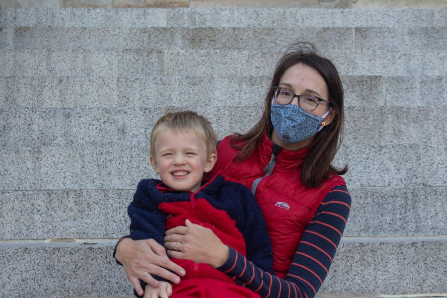 University of Iowa Lecturer of Earth and Environmental Sciences, Mary Kosloski, and her son, Felix, pose for a portrait at the Pentacrest on Oct. 16. 