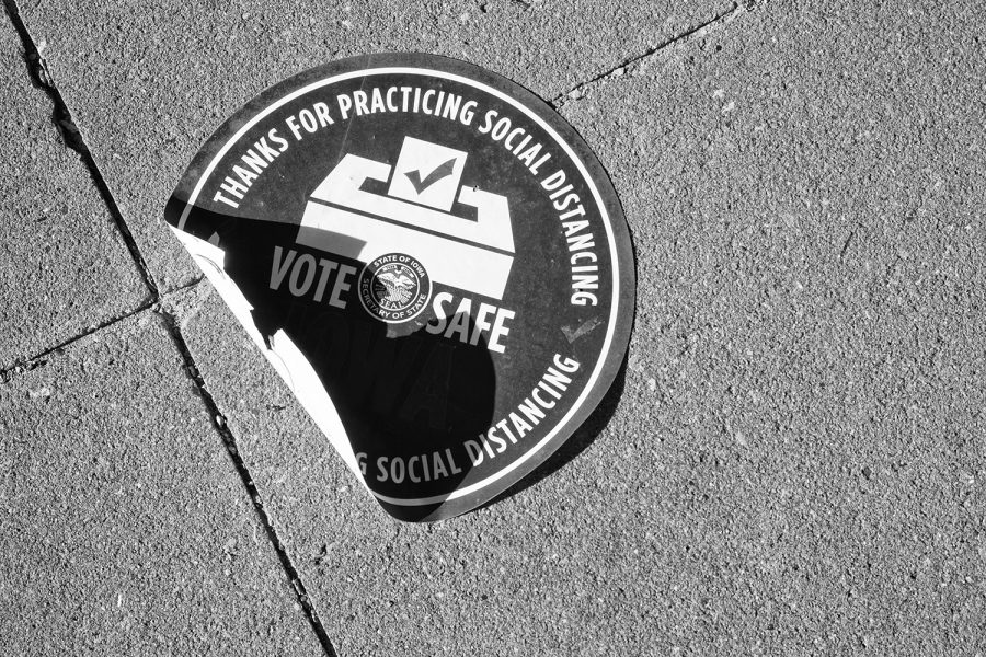 A sticker on the ground indicating social-distancing is seen outside a Coralville polling location on Tuesday, Nov. 3, 2020. 