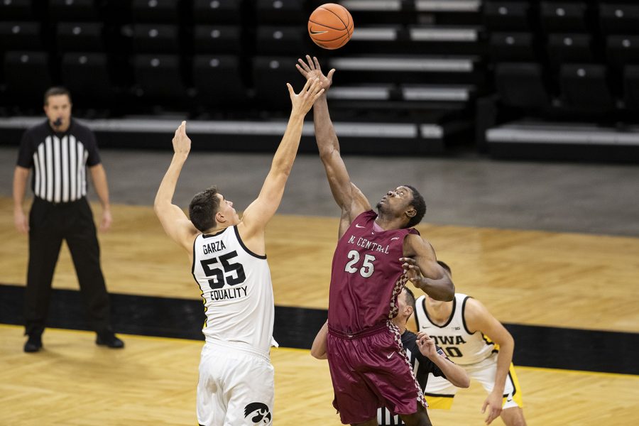 Iowa center Luka Garza jumps up for the tipoff during the first Iowa men’s basketball game of the season against the North Carolina Central Eagles at Carver-Hawkeye Arena on Wednesday, Nov. 25, 2020. North Carolina Central gained the first posession. The Hawkeyes defeated the Eagles 97-67. 
