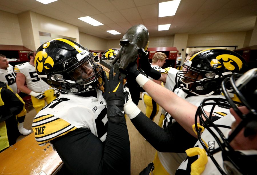 Iowa Hawkeyes defensive lineman Chauncey Golston (57) celebrates with the Floyd of Rosedale Trophy against the Minnesota Golden Gophers Friday, November 13, 2020 at TCF Bank Stadium. (Brian Ray/hawkeyesports.com)