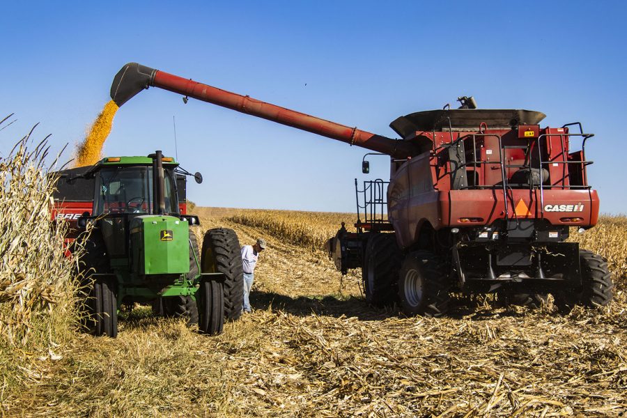 Jim Hemesath unloads so to make another pass on Oct.8,2020.onthe Brockschink family farm, Norway, Ia. While Nick Schulte stands by as the corn is loaded into the wagons.