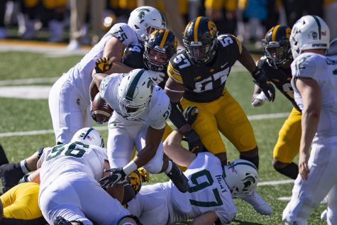 Iowa defensive end Chauncey Golston pursues the running back during a football game between Iowa and Michigan State on November 7, 2020.