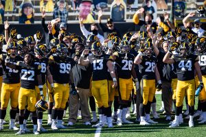 Iowa players take place in The Wave during a football game between Iowa and Michigan State in Kinnick Stadium on Saturday, Nov. 7, 2020. The Hawkeyes dominated the Spartans, 49-7. 