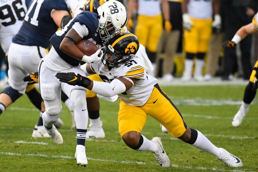 University Park, Pennsylvania, USA; Iowa Hawkeyes defensive lineman Chauncey Golston (57) tackles Penn State Nittany Lions running back Devyn Ford (28) during the first quarter at Beaver Stadium. Mandatory Credit: Rich Barnes-USA TODAY Sports