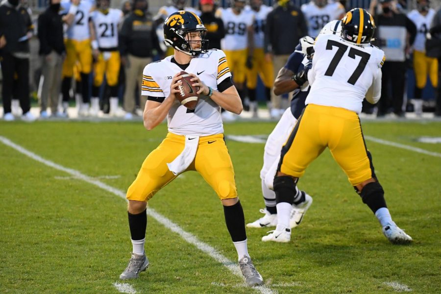 Nov 21, 2020; University Park, Pennsylvania, USA; Iowa Hawkeyes quarterback Spencer Petras (7) drops back to pass against the Penn State Nittany Lions during the second quarter at Beaver Stadium. Mandatory Credit: Rich Barnes-USA TODAY Sports