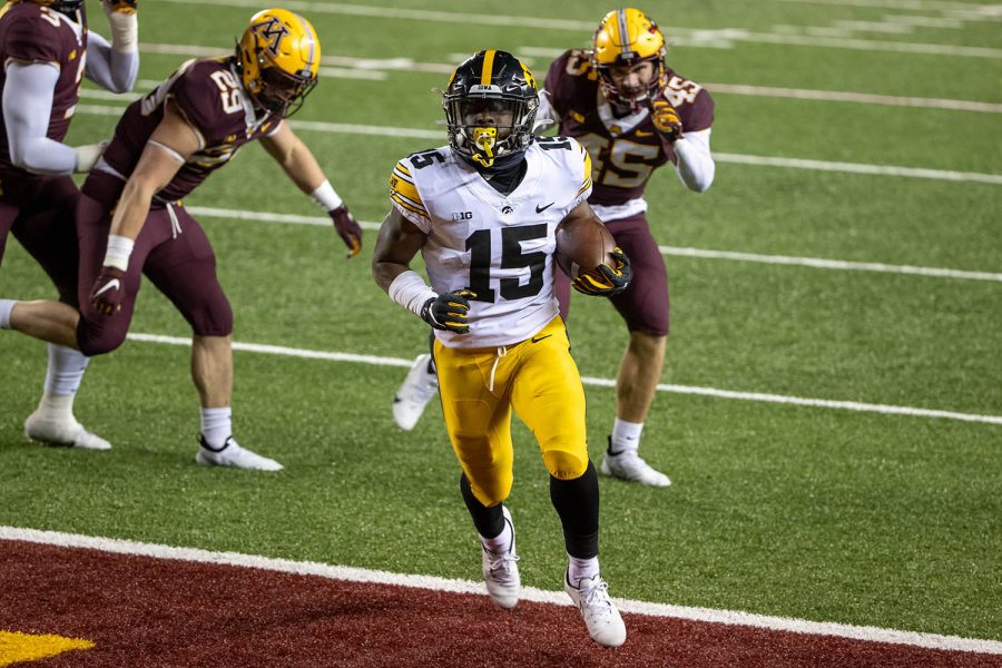 Nov 13, 2020; Minneapolis, Minnesota, USA; Iowa Hawkeyes running back Tyler Goodson (15) rushes for a touchdown in the second half against the Minnesota Golden Gophers at TCF Bank Stadium. (Jesse Johnson-USA TODAY) 