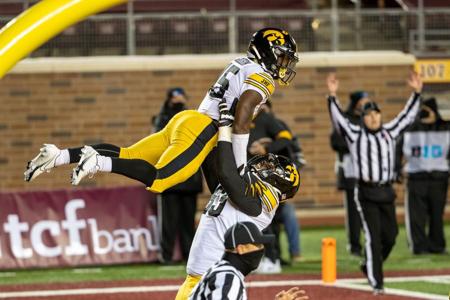 Nov 13, 2020; Minneapolis, Minnesota, USA; Iowa Hawkeyes running back Tyler Goodson (15) celebrates with offensive lineman Justin Britt (63) after scoring a touchdown in the first half against the Minnesota Golden Gophers at TCF Bank Stadium. (Jesse Johnson-USA TODAY) 