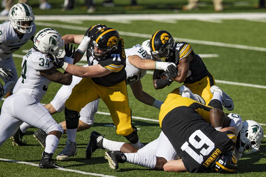 Iowa running back Tyler Goodson carries the ball during a football game between Iowa and Michigan State in Kinnick Stadium on Saturday, Nov. 7, 2020.