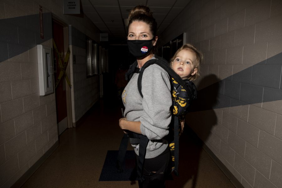 North Liberty resident Katie Brown, 31, and son Barret Brown stand for a portrait in the hallway of a polling location at the North Liberty Community Center in North Liberty on Tuesday, November 3, 2020. Brown is a stay-at-home mom and came to vote while her husband worked on a call. Brown voted democrat down the ticket. 