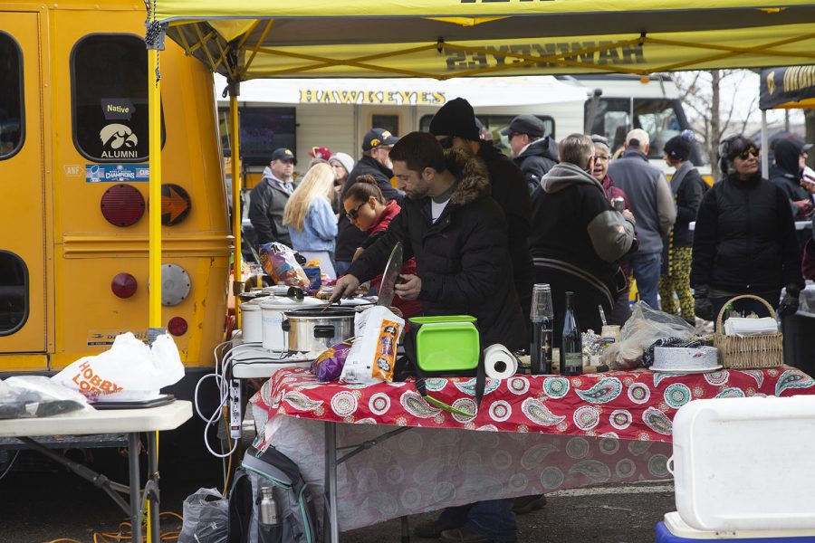 Tailgaters dish up food before the Iowa football game against No. 7-ranked Minnesota on Saturday, Nov. 16, 2019.