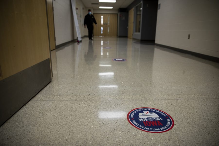 Stickers indicating where to stand fill the hallway outside a polling location at North Bend Elementary school in North Liberty on Tuesday, November 3, 2020. In 2016, Johnson County was one of six Iowa counties to vote for a democratic presidential candidate, according to the New York Times. 