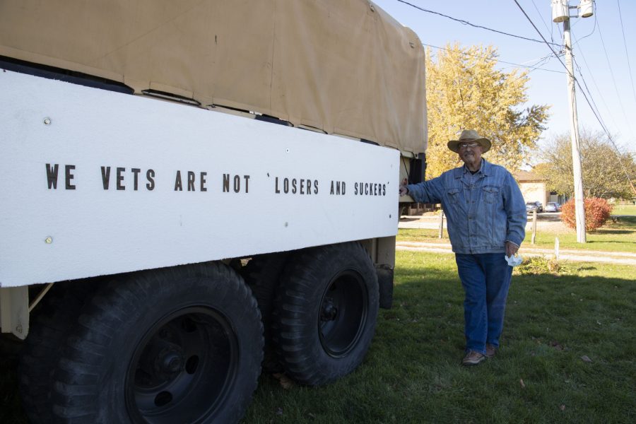 Veteran Eric Morris poses for a portrait in front of his 1970 US Army Deuce and a Half, temporarily parked on former mayor Jonathan Green’s front lawn in Lone Tree, Iowa. Morris said he attended Admiral Farragut  Academy in New Jersey when President Trump attended New York Military Academy. “When I was a senior and he was a sophomore I assume––I don’t remember him––but I assume he never played on varsity as a sophomore, so I didn’t get a chance to actually knock him on his ass. But I wish I did.” Morris said many Lone Tree residents typically vote for republican candidates, but liberal voters in the rest of Johnson County, especially in Iowa City, overpower them.