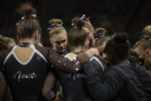 Iowa’s all-around Allyson Steffensmeier huddles with her teammates during a gymnastics meet at Carver Hawkeye Arena against Michigan State on Saturday, Feb. 1, 2020. The Hawkeyes won three out of four events against the Spartans with a score, 195.450-195.275.