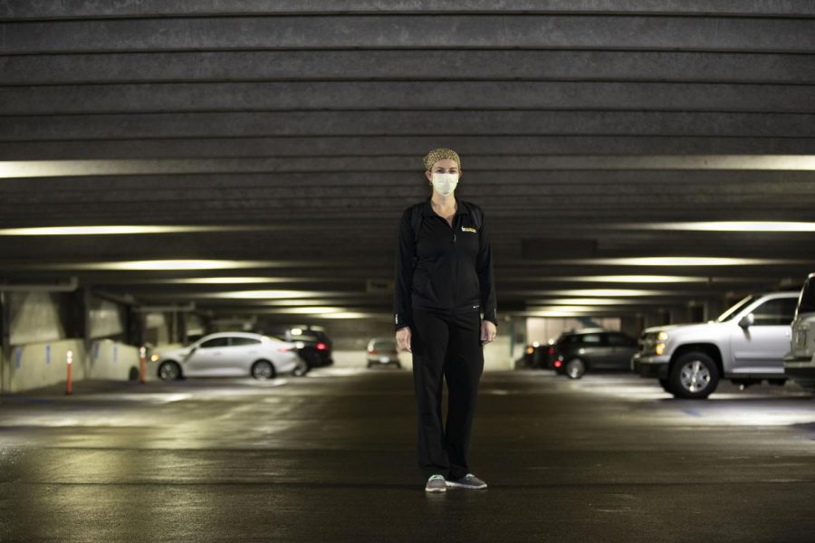 Registered Nurse Lilly Olson poses for portraits in a parking ramp on Tuesday Nov. 24, 2020 at UIHC. Olson works 24-36 hours per week, seeing between one and four patients per shift. “We try to fight each battle as best we can,” Olson said, “but unfortunately we don’t win them all.” 
