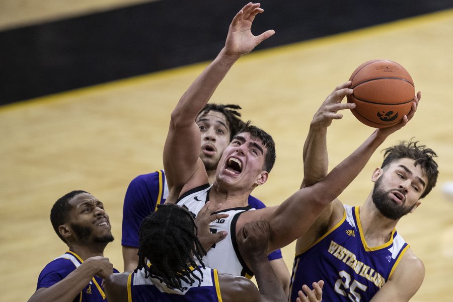Iowa Center Luka Garza fights for a rebound during the Iowa v. Western Illinois basketball game in Carver-Hawkeye Arena on Thursday, Dec. 3, 2020. Iowa defeated Western Illinois with a final score of 99-58.