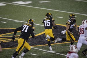 Dec. 12, 2020; Iowa City, Iowa, USA; Iowa running back Tyler Goodson (15) makes a touchdown after an 80 yrd. drive to the end zone during the fourth quarter of the Iowa v. Wisconsin football game at Kinnick Stadium. Iowa defeated Wisconsin with a score of 28-7.