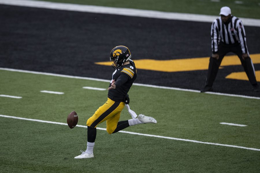 Dec. 12, 2020; Iowa City, Iowa, USA; Iowa punter Tory Taylor punts the ball away during the first quarter of the Iowa v. Wisconsin football game at Kinnick Stadium. Iowa leads Wisconsin with a score of 6-0 at halftime. Mandatory Credit: Katie Goodale/Daily Iowan via USA TODAY Network