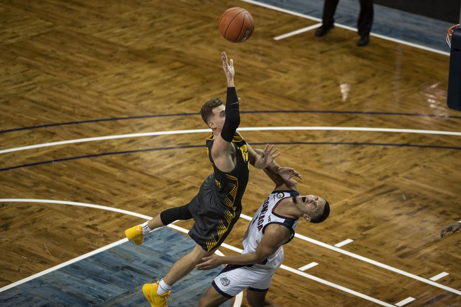 Saturday, Dec. 19, 2020; Sioux Falls, South Dakota, USA;  Iowa guard Jordan Bohannon attempts to score, while Gonzaga guard Jalen Suggs (1) is hit in the face during the first half of the Iowa v. Gonzaga basketball game at the Sanford Pentagon. Gonzaga basketball game at the Sanford Pentagon. Gonzaga leads against Iowa with a score of 51-37 after the first half. Mandatory Credit: Katie Goodale/Daily Iowan via USA TODAY Network
